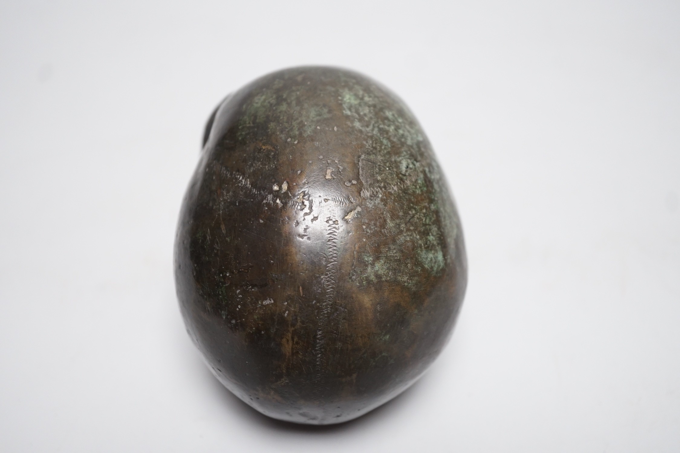 A bronze model of a skull, once part of a larger piece. 13cm deep